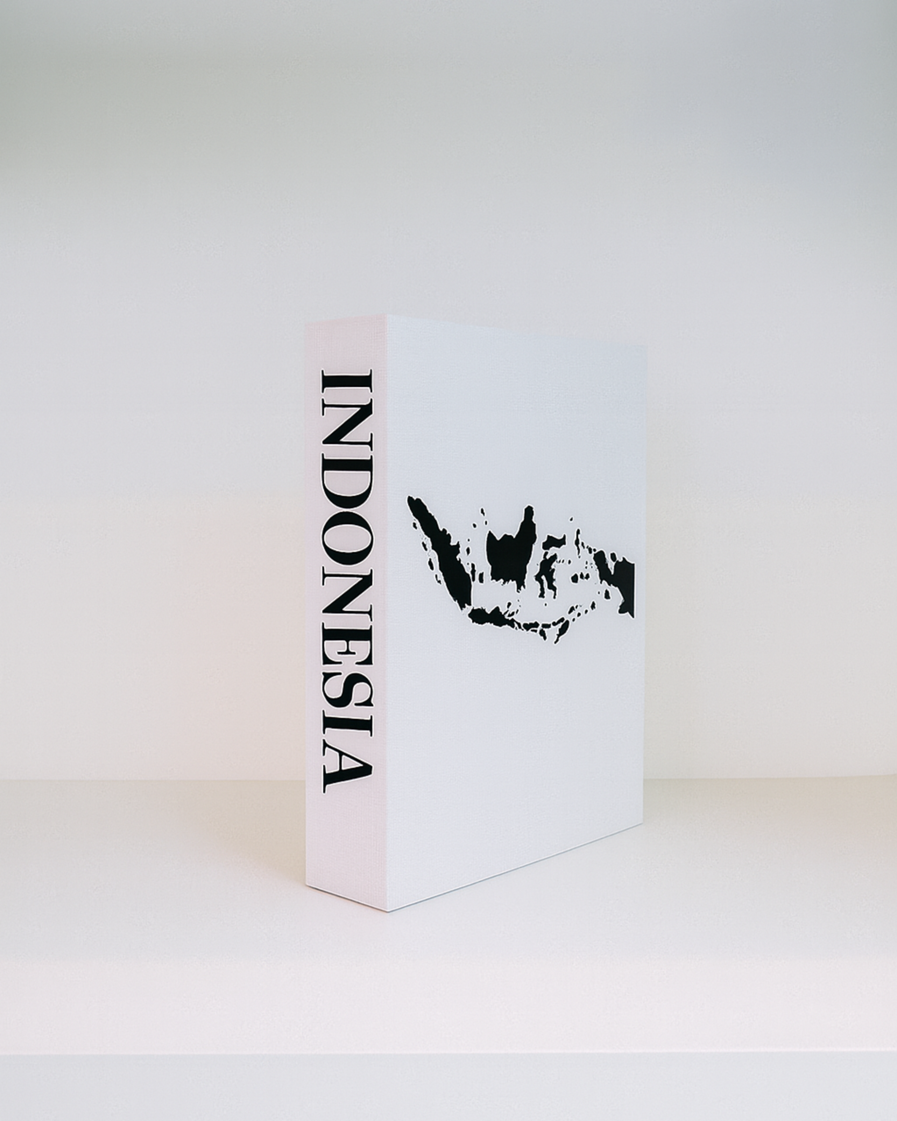 White book with 'Indonesia' and a logo on a white background