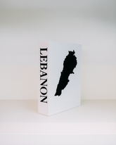 White box with black silhouette of Lebanon and 'LEBANON' text on a white background