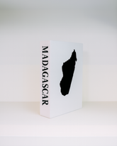 White box with a black silhouette of Madagascar and 'Madagascar' text on a white background