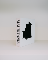 White box with black silhouette of Mauritania and 'MAURITANIA' text on a white background