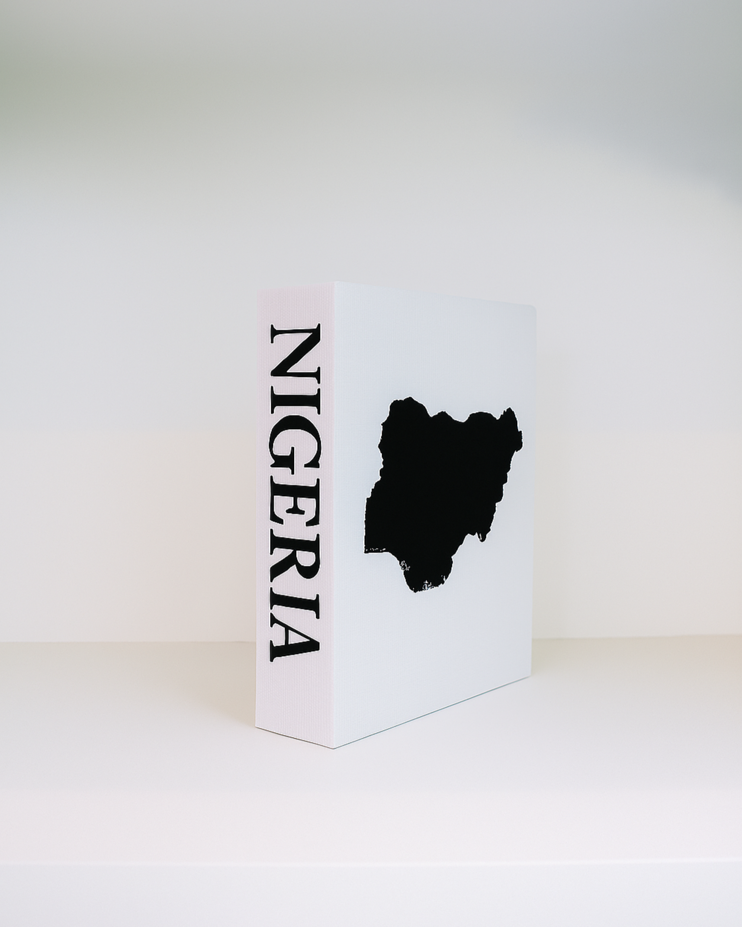 White box with 'Nigeria' text and black silhouette on a white background