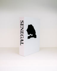 White book with black silhouette of Senegal and 'Senegal' text on a white background