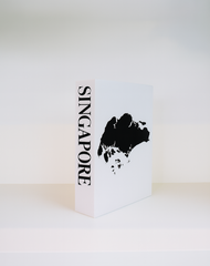 White book with black silhouette of Singapore and 'Singapore' text on a white background
