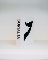 White box with black silhouette of Somalia and 'Somalia' text on a white background