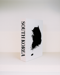 White book with black silhouette of South Korea and 'SOUTH KOREA' text on a white background