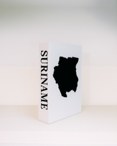 White box with black silhouette of a country and 'Suriname' text on a white background