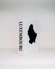 White box with black silhouette of Luxembourg and 'LUXEMBOURG' text on a white background