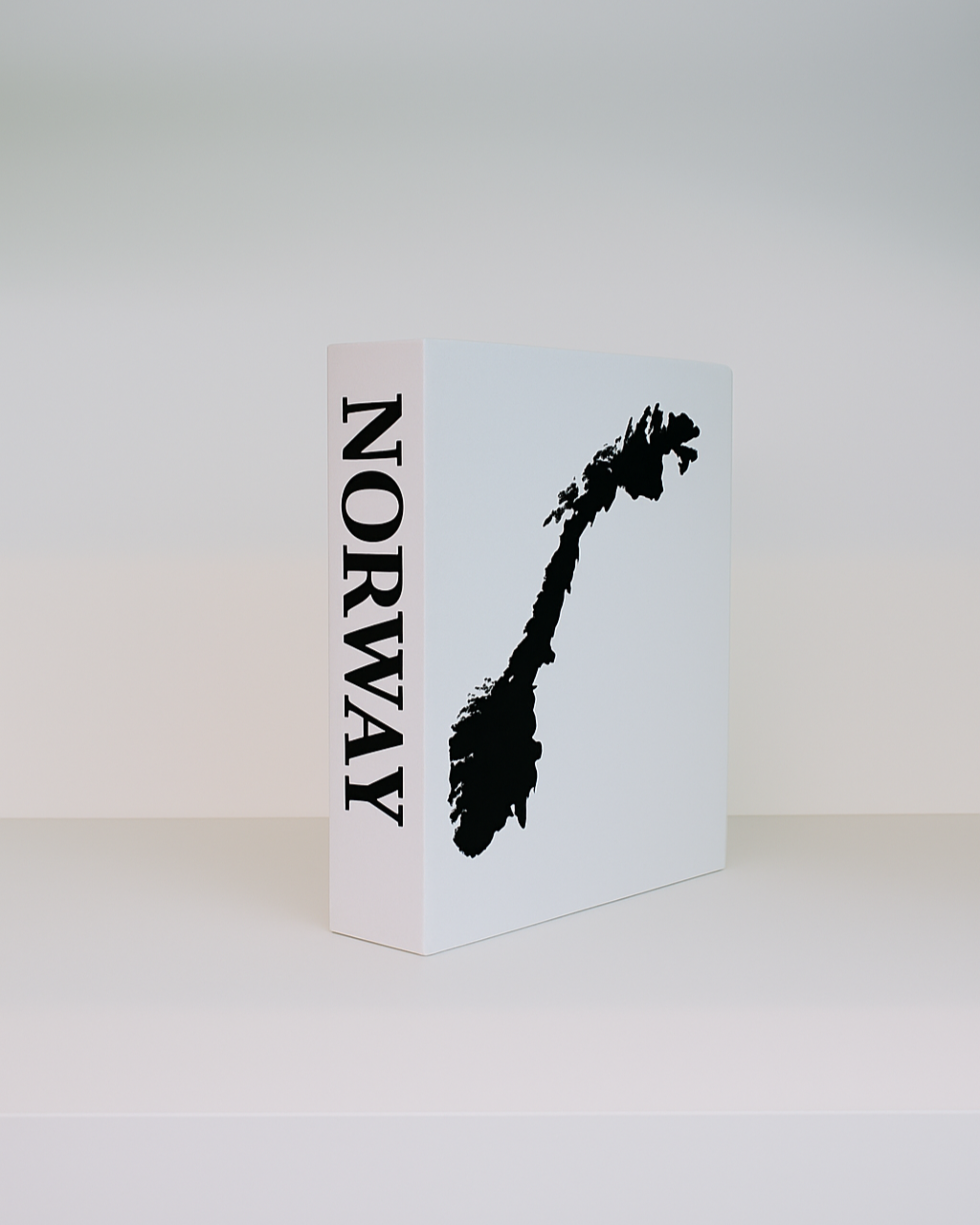 White book with black silhouette of a mountain and 'Norway' text on a white background