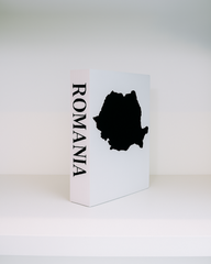White box with black silhouette of Romania and 'ROMANIA' text on a white background