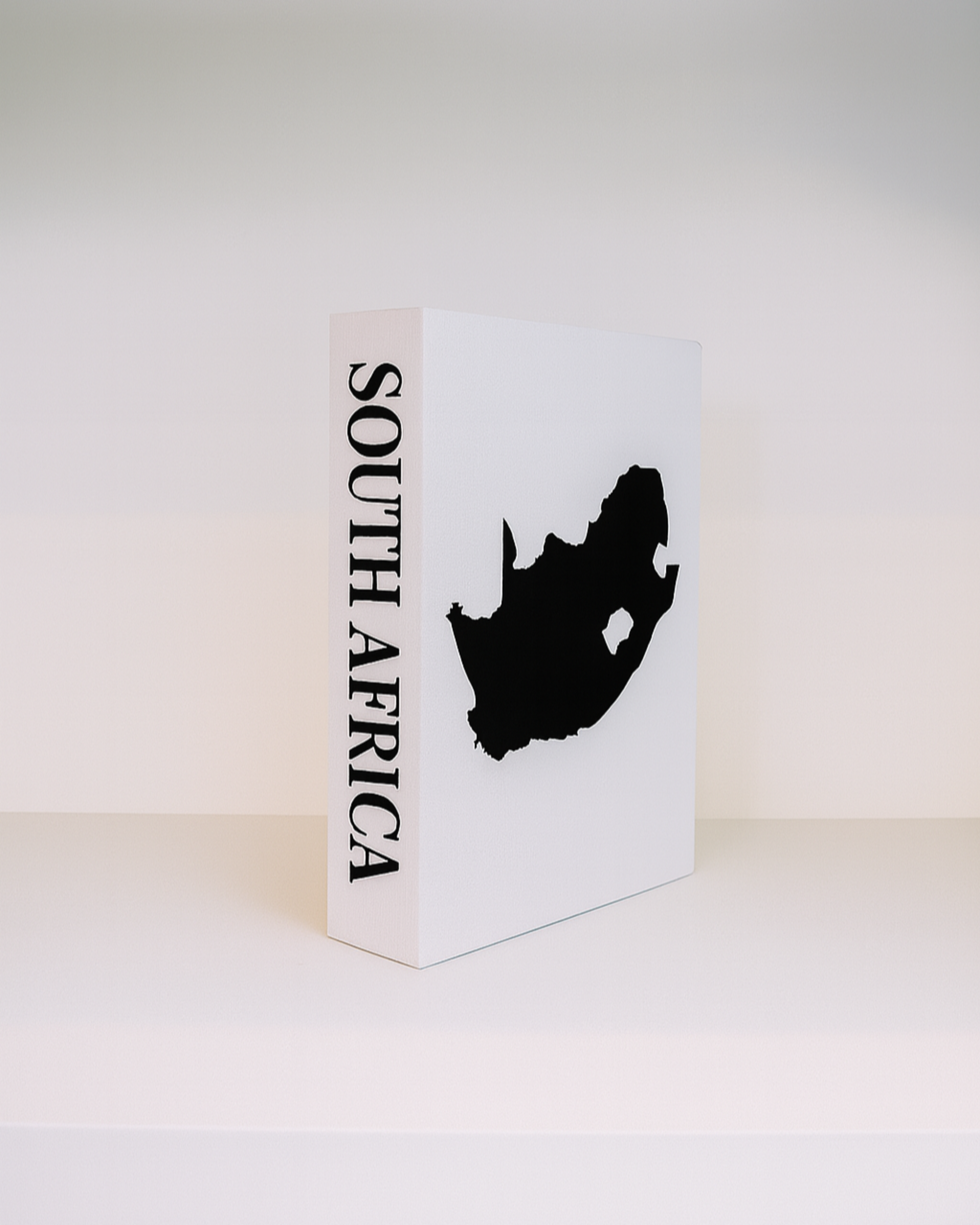 White box with a black silhouette of South Africa and 'South Africa' text on a white background